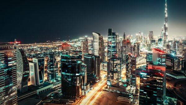 Fantastic nightime skyline: big futuristic city with illuminated world tallest skyscrapers. Dubai downtown, United Arab Emirates. Colorful travel and architectural background.